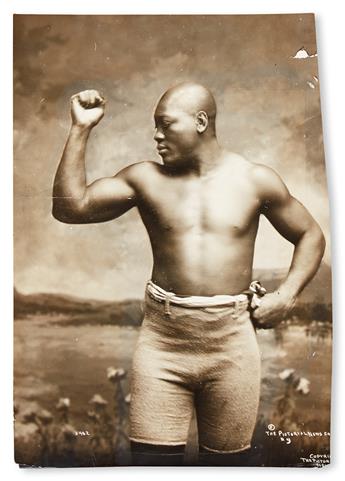 (SPORT--BOXING.) JOHNSON, JACK. The Champ, flexing his muscle